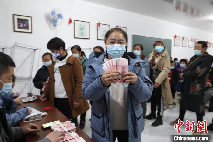 圖為肖主拉領(lǐng)到了“工資”?！】朴抑衅煨麄鞑抗﹫D